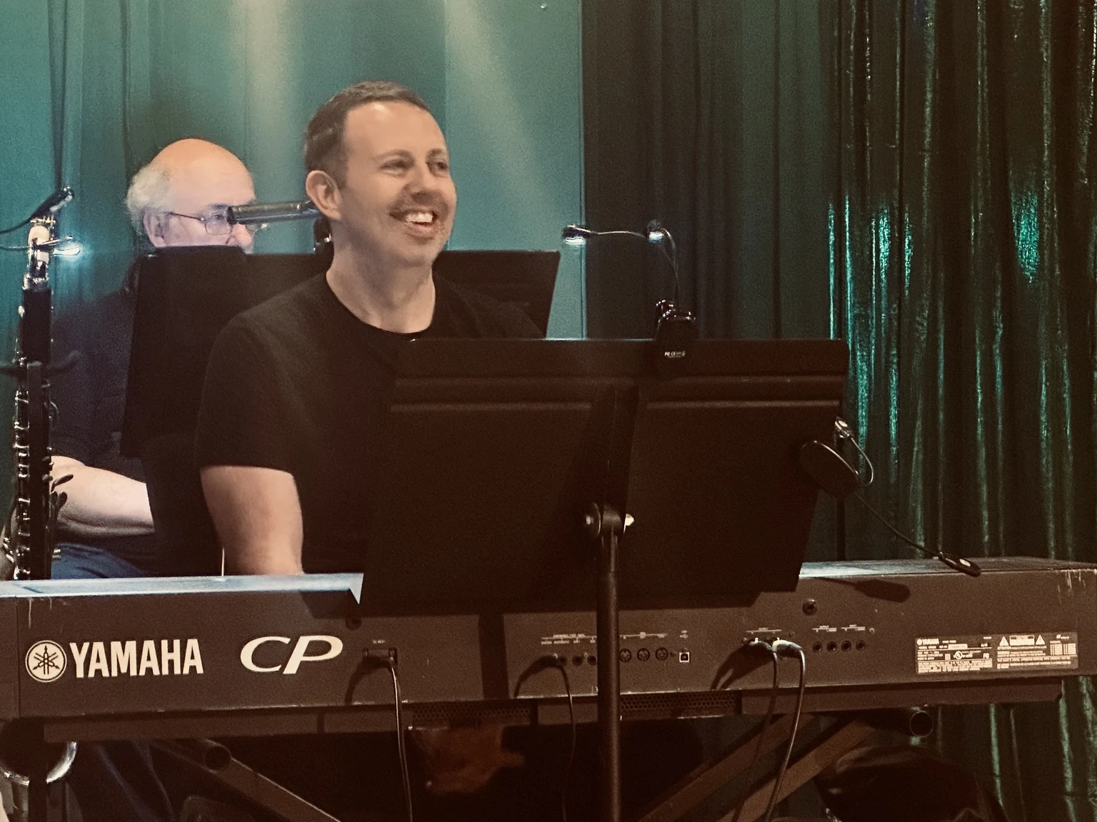 Daniel smiling while performing behind a Yamaha keyboard